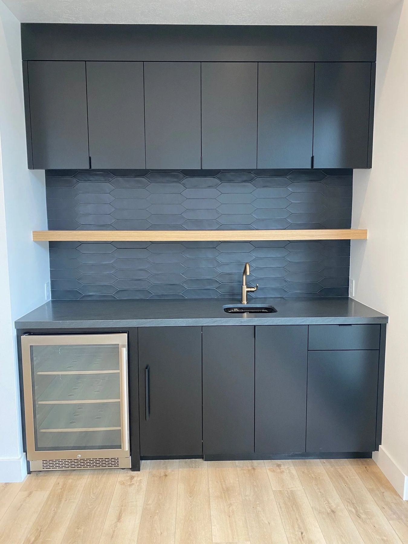 Matte black wet bar with white oak floating shelf