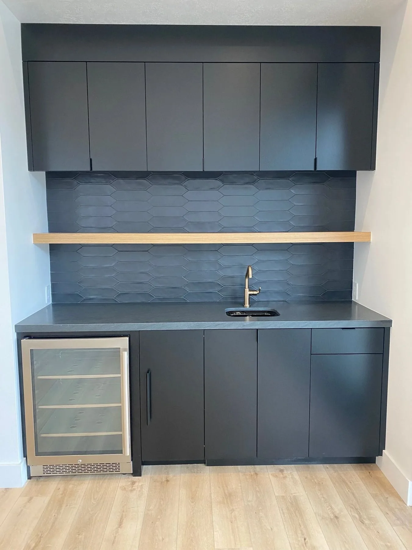 Matte black wet bar with white oak floating shelf
