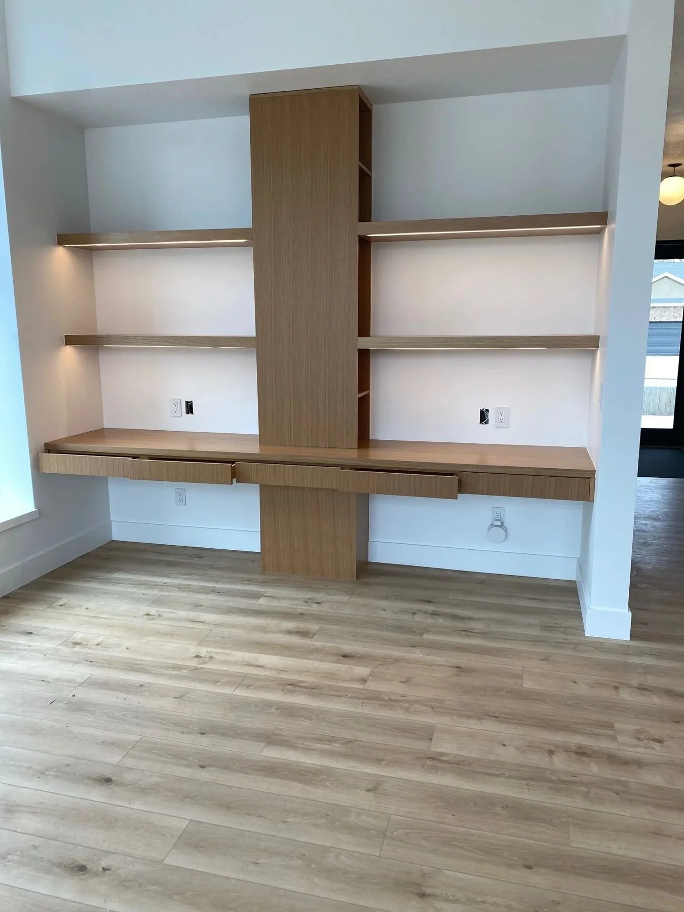 Light oak office shelving and built-in desk