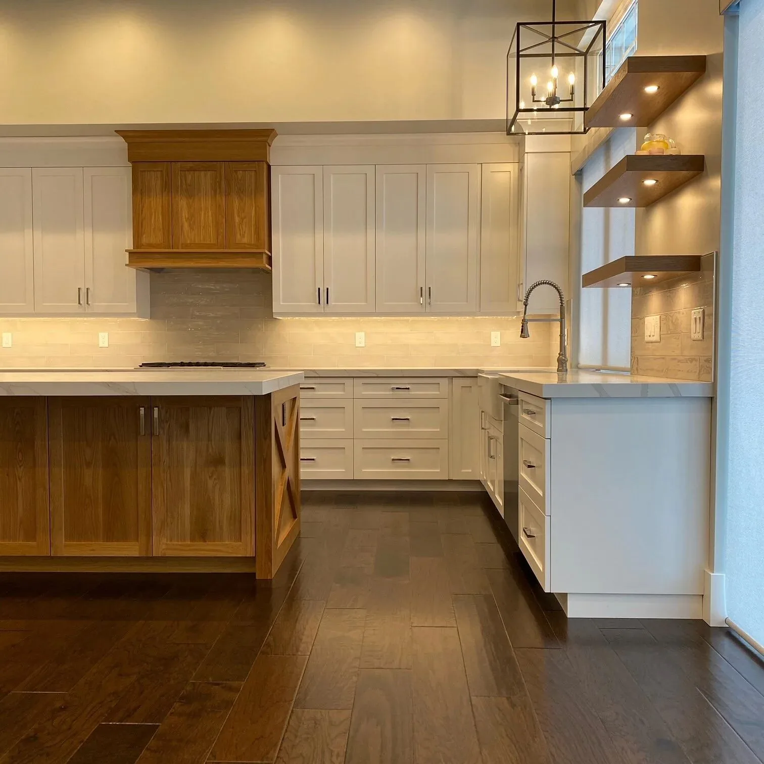 White kitchen with wood range hood and dark island